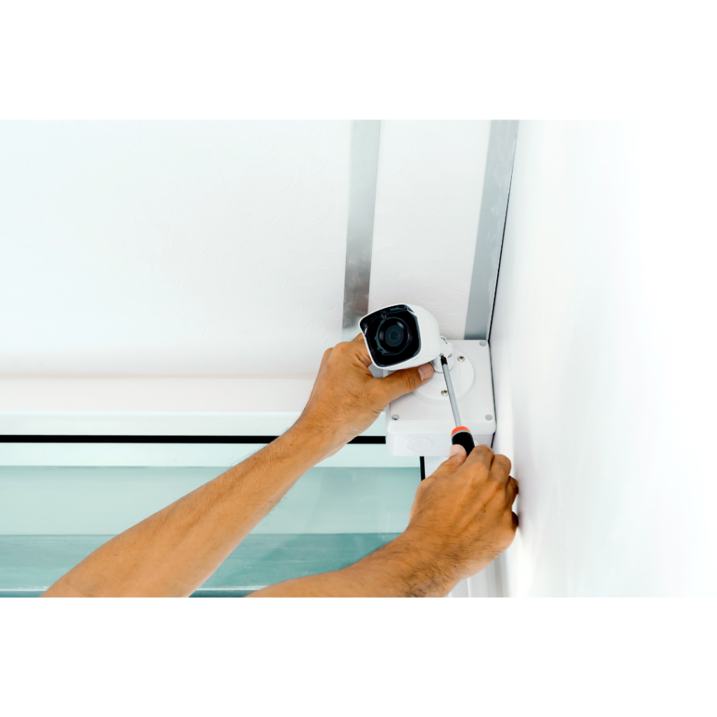 A man installing a cctv camera